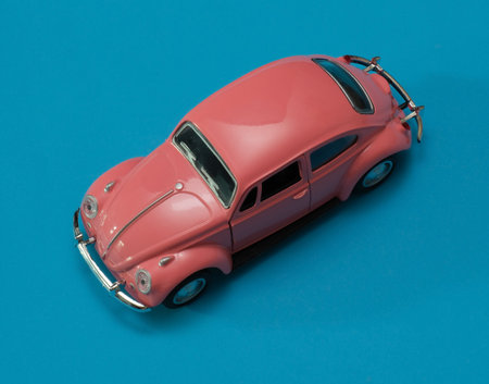 pink vintage retro car toy on blue background