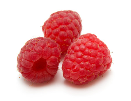 red raspberry berry group isolated on white background