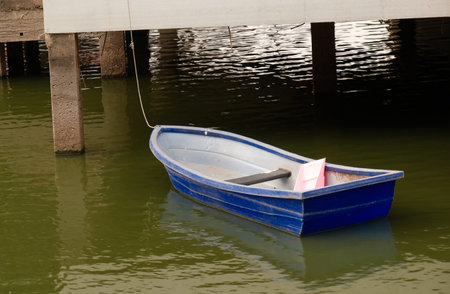 small blue boat in water of temple lake without people