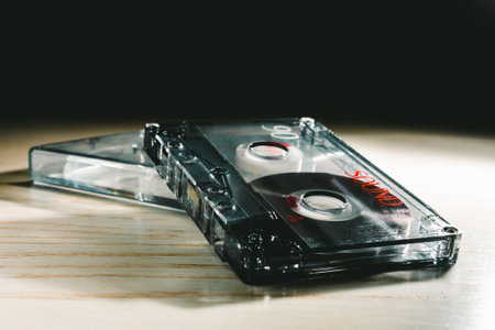 A black audio tape close up shot. Old audio cassette on a table with a black background.の写真素材