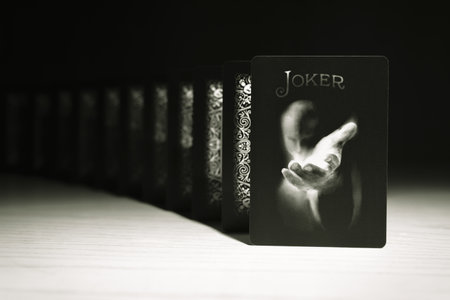 A Joker of Bicycle Black Ghost Second Edition Playing Cards deck on a black background, close up shot. A Joker card on a black background. Russia, Saint-Petersburg, 12 June 2022.のeditorial素材