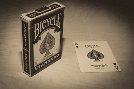 Old deck of Bicycle Playing Cards Standart and Ace of spades on a wooden background-vintage filter. Russia, Saint-Petersburg, 12 June 2022.のeditorial素材