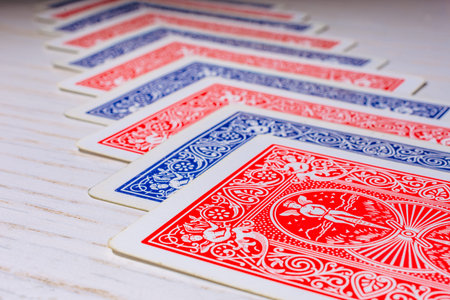 Multicolored poker cards on a wooden background. Background of multicolored poker cards. Russia,...