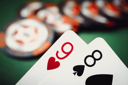 Poker background. Nine of hearts and eight of spades on a green background close up.