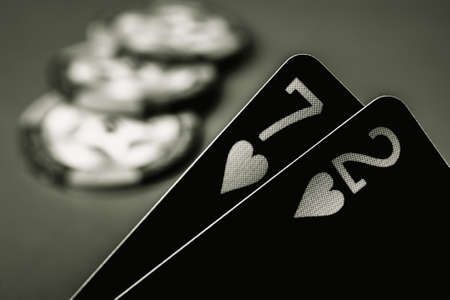 Poker playing cards seven and two close-up in black and white style. Texas holdem. Born to win. Born to lose.の写真素材
