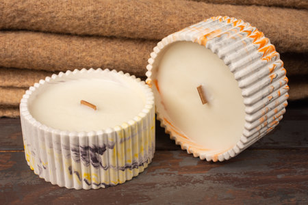 A set of different aroma candles. Scented handmade candle on a wooden background. Soy candles Aromatherapy and relax in spa and home.の写真素材