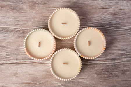 A set of different aroma candles. Scented handmade candle on a wooden background. Soy candles Aromatherapy and relax in spa and home.の写真素材