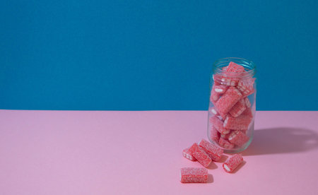 Glass with candy bears on the table