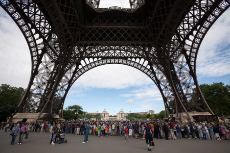 Paris, France - July 1, 2007. People and tourists visit Eiffel Tower in Paris on July 1, 2007. The...