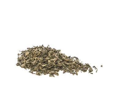 Dried green tea leaves on a white background. の写真素材