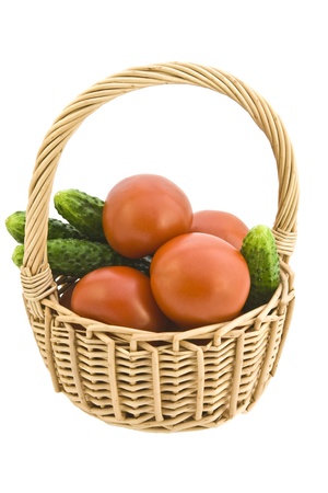 Basket with cucumbers and tomatoes on a white background..の写真素材