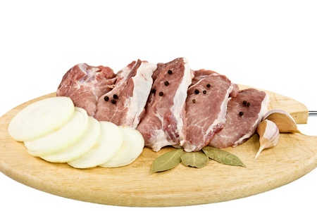 The pieces of meat with spices on a cutting board, in isolation.の写真素材