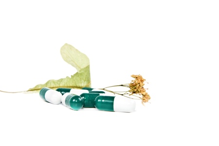 Dry flower linden and the pills on a white background.の写真素材
