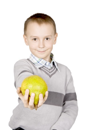 The child works on a pear for treats. The focus on the foreground.の写真素材