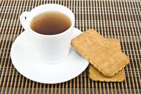 A cup of black tea and biscuits.の写真素材