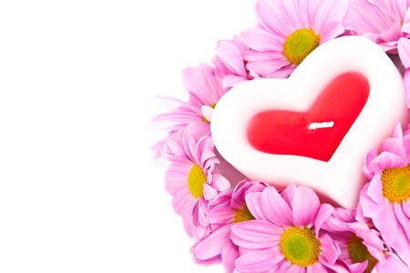 Postcard for lovers with a candle in the form of hearts and flowers on a  white  background の写真素材