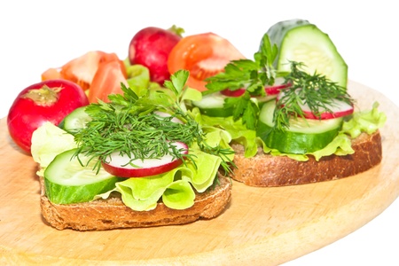 Diabetic bread and vegetable cutting on a white background Focus on the first plan の写真素材