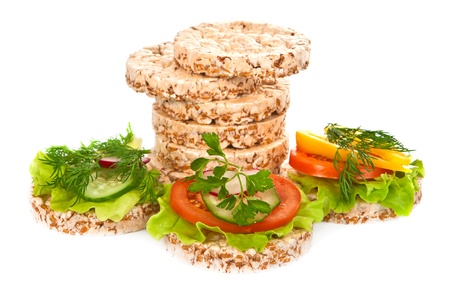 Grain breads and vegetable cutting on a white background の写真素材