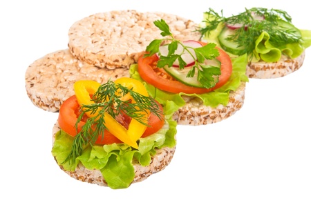 Grain breads and vegetable cutting on a white background Focus on the first plan の写真素材