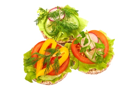 Grain breads and vegetable cutting on a white background の写真素材
