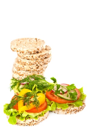 Grain breads and vegetable cutting on a white background の写真素材
