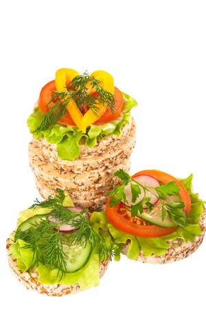Grain breads and vegetable cutting on a white background Focus on the first plan の写真素材
