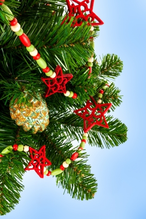 Part of the Christmas tree, decorated with toys on a blue background の写真素材
