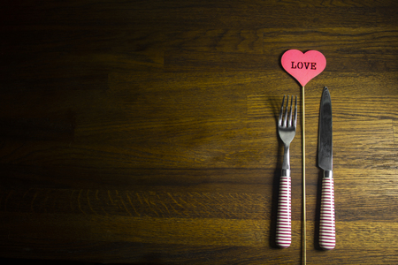 Wooden rustic table set for Valentines Day with red heart. copy space. Loveの写真素材
