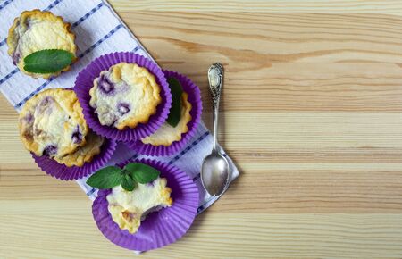 cheese blueberry muffins on a wooden background. flat lay, copy spaceの写真素材