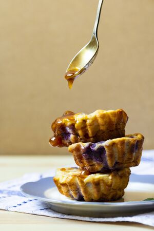 stack of blueberry cheese muffins with honeyの写真素材
