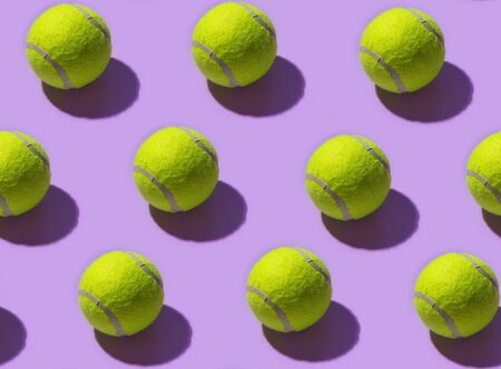 Seamless pattern with tennis balls on a light purple backgroundの写真素材