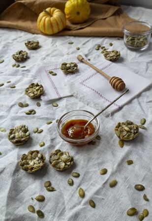 Organic candy made with pumpkin seeds. Fitness Cookies on a linen tablecloth. monochrome colorsの写真素材