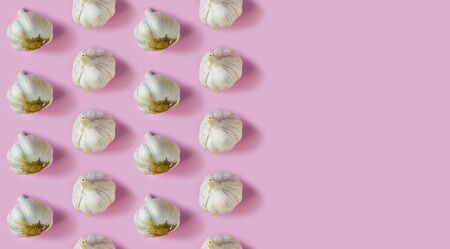 Seamless garlic pattern on a pink background, Copy space. Vitamin conceptの写真素材