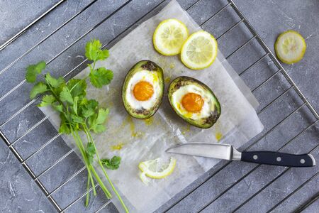 baked egg in avocado Boats. Top view, flat layの写真素材