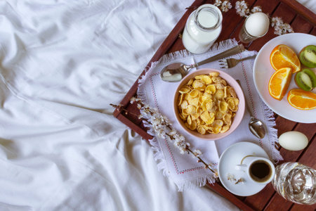 Romantic Breakfast in bed with spring flowers. Flat lay, copy space