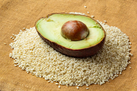 Hulf of avocado on sesame seeds. food ingredient preparation for ketogenic diet meal plan