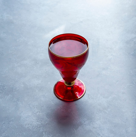 Beautiful red glass on grey background