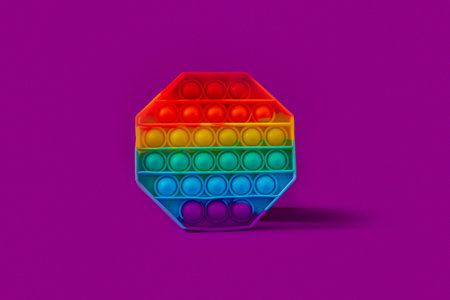 Silicone octagon toy fidget popping toy on purple backgroundの写真素材