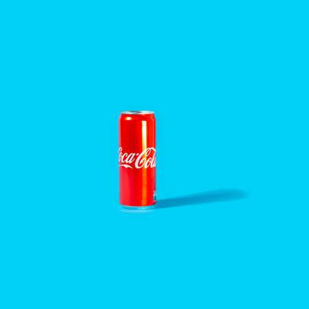 UKRAINE, KIEV - SEPTEMBER 09, 2021: Coca-Cola can on blue backgroundのeditorial素材