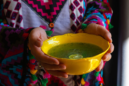 female hands with Egyptian Molokhia soup