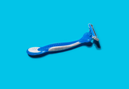 Disposable shaving razors on blue background