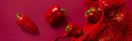 Fresh bell peppers in eco friendly bag. Monochrome red coloursの写真素材