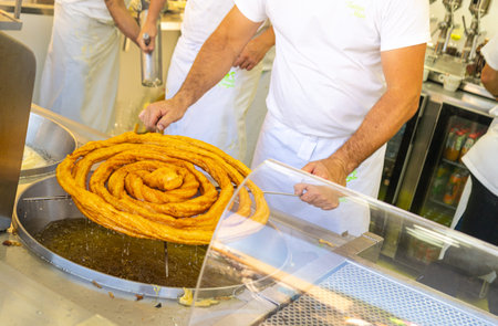 A man making churros in a bar
