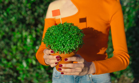 Woman with Manjerico plant outdoors
