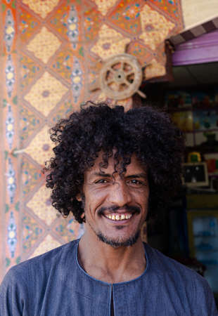 Happy curly arab man portraitの写真素材