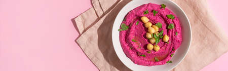 Beetroot hummus on pink background, top viewの写真素材