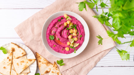 Beetroot hummus on white table, top viewの写真素材