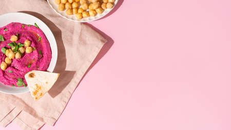 Beetroot hummus on pink background, top view and copy spaceの写真素材