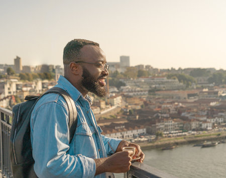 Traveller man drinking coffee on the Oporto bridgeの写真素材