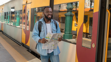 Young adult man with map at terminal train station
